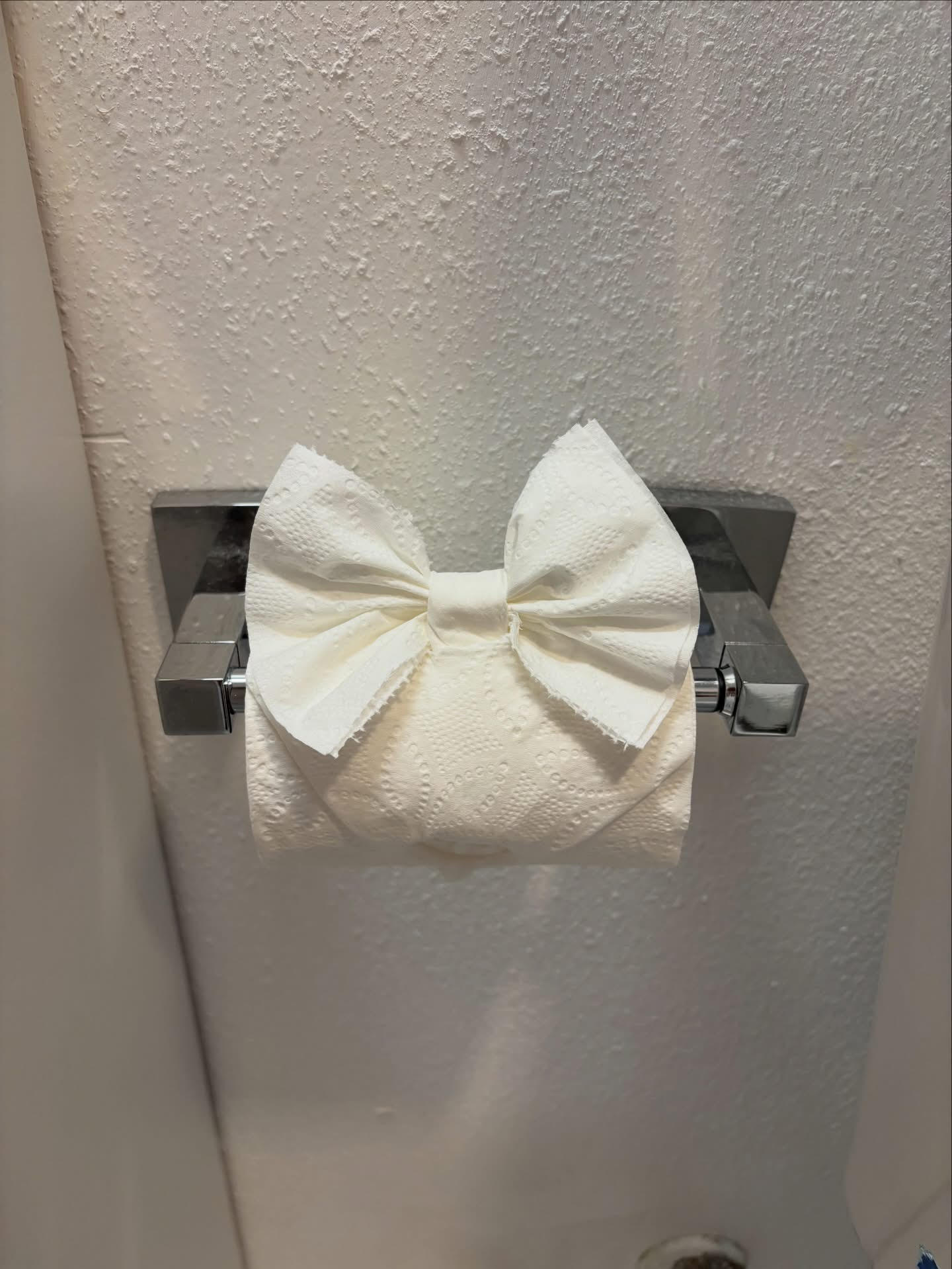 toilet paper folded into a bow